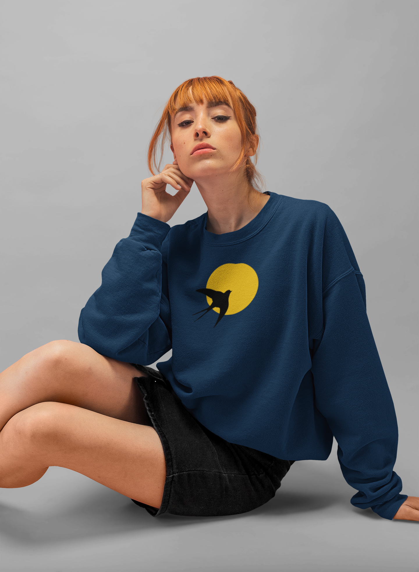 Front view of the Bold Andorinhas Unisex Sweater, featuring a large Portuguese-inspired swallow design.