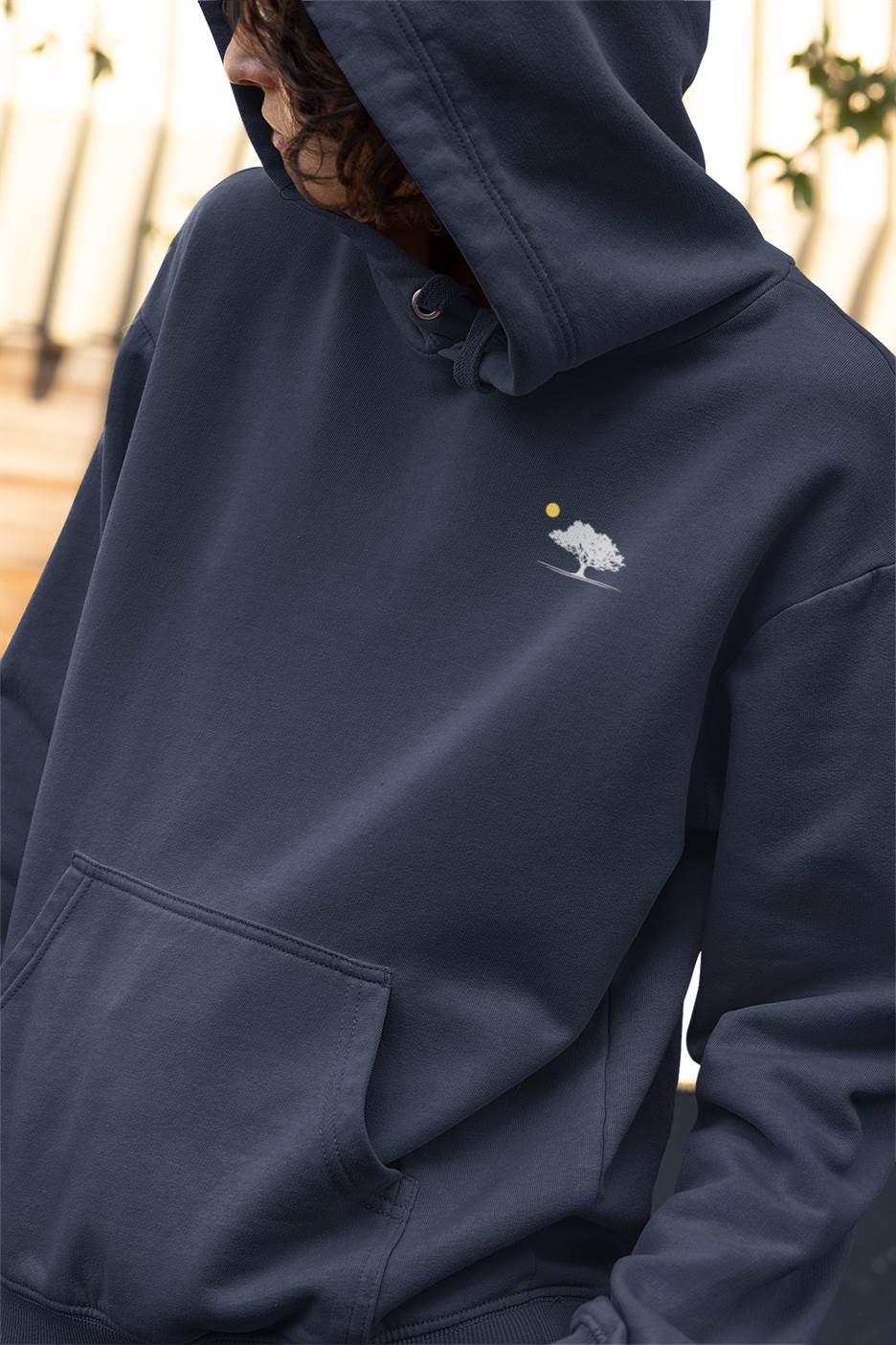 Close-up of the organic cotton fabric with the oak tree sunset logo on the hoodie.