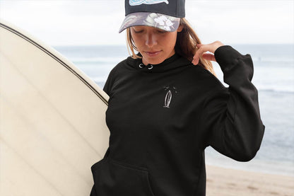 Detailed view of the minimalist surfboard logo on the Nazare-inspired hoodie