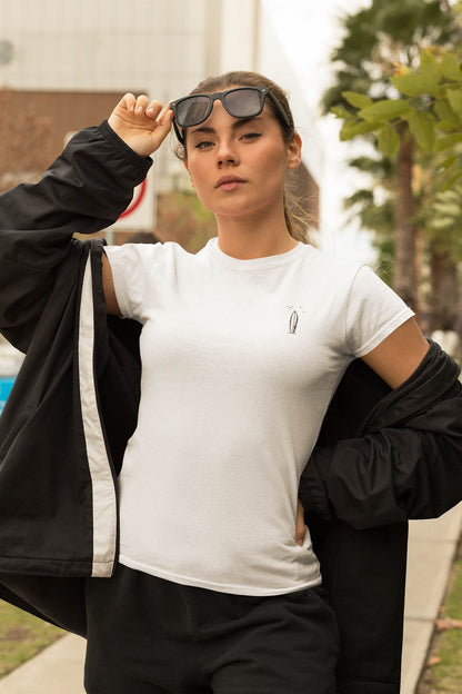 Detailed view of the minimalist surfboard logo on the Ericeira-inspired women’s T-shirt.